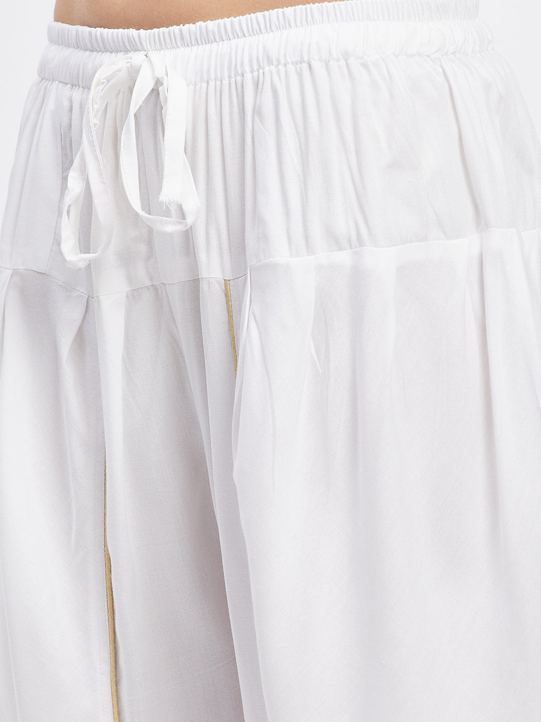 White solid rayon tulip pant with elasticated waistband and drawstring.