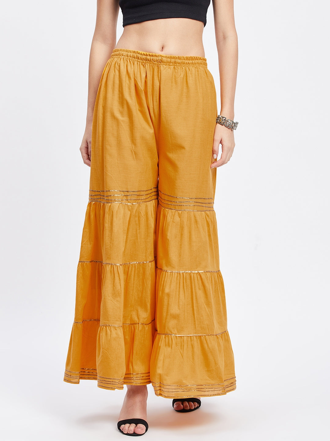 Mustard cotton Gotta Patti gharara with elastic waistband and flared hem.