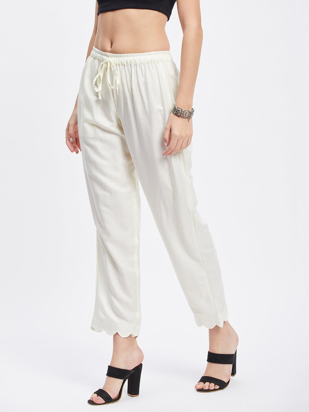 Off-White Solid Rayon Straight Palazzo with elastic waistband and drawstring.