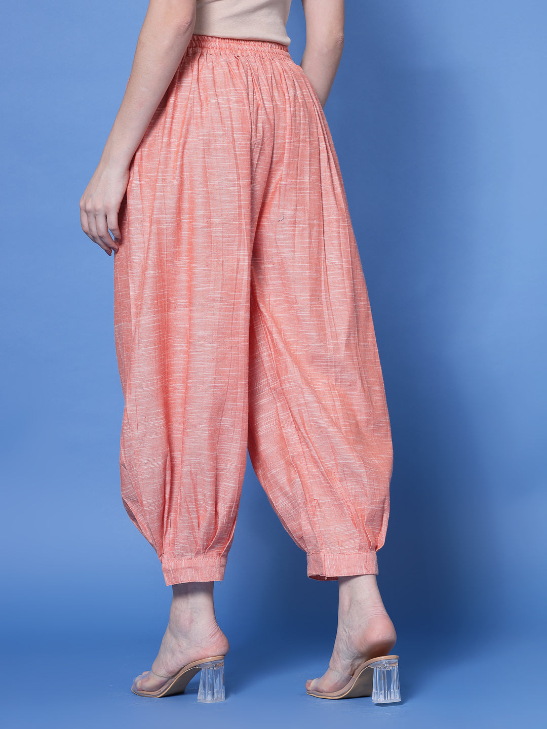 Peach self-design cotton loose fit Afghani salwar with elasticated waistband and embellished hemline.