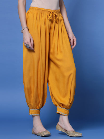 Mustard rayon Afghani salwar with embellished hem and elasticated waistband.