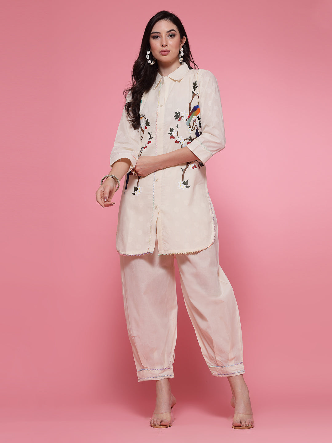 Off-white printed shirt with Afghani salwar co-ord set featuring embroidery on kurti cuffs and salwar hem, three-quarter sleeves.