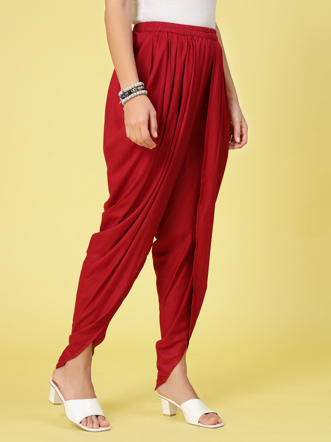 Women wearing red solid rayon dhoti salwar with elasticated waistband and pleated details.