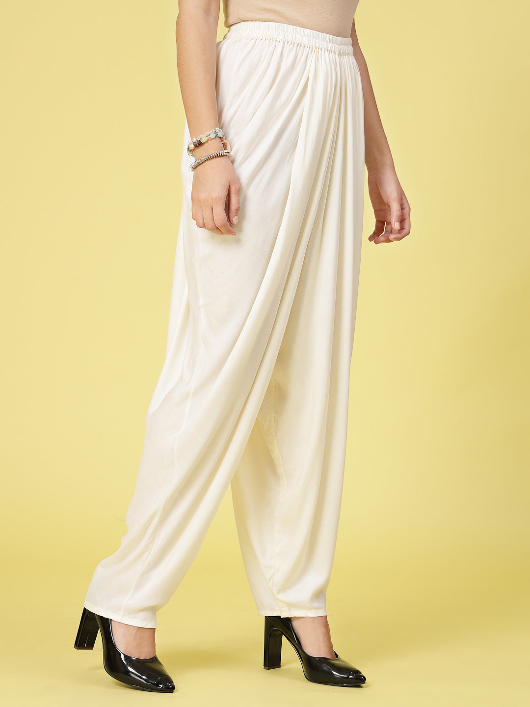 Women Solid Rayon Dhoti Salwar with elasticated waistband and curved hemline.