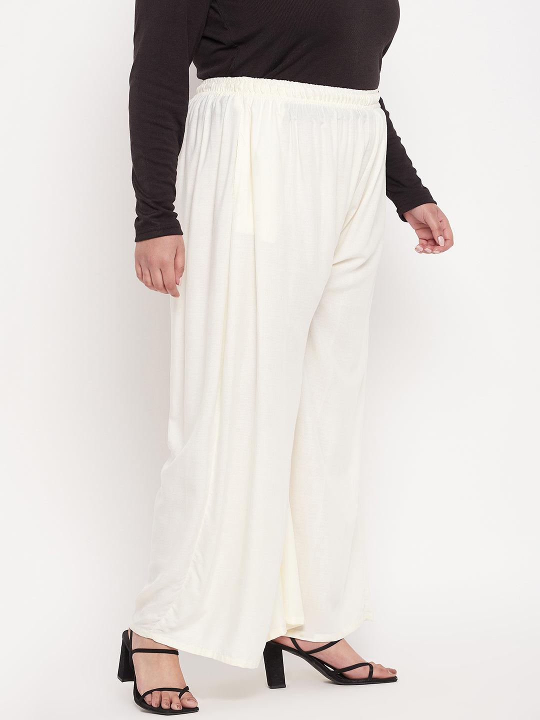 Off-white solid rayon jumbo sharara with elasticated waistband and drawstring.