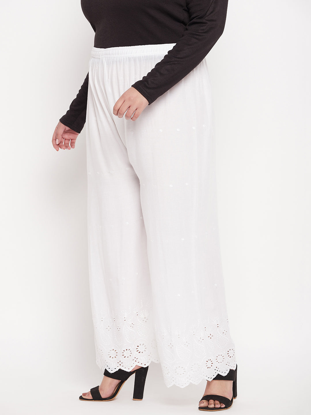 White embroidered rayon palazzo with elasticated waistband and drawstring.