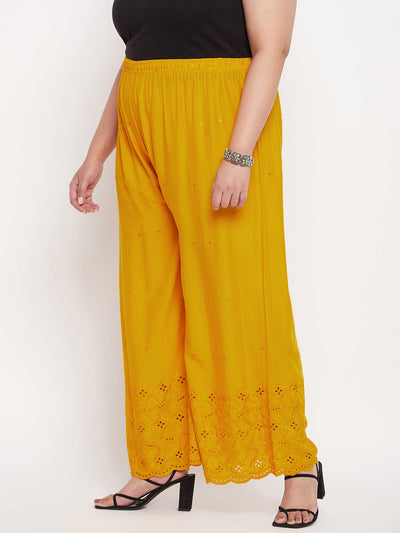 Mustard embroidered rayon palazzo with Chikankari design and elastic waistband.