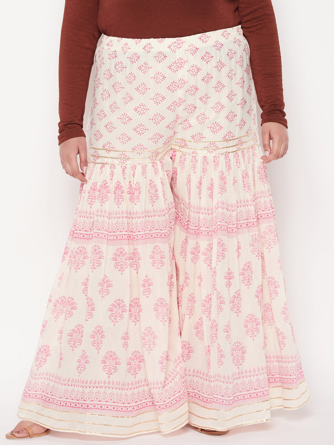 White and magenta printed cotton flared gharara with elasticated waistband.