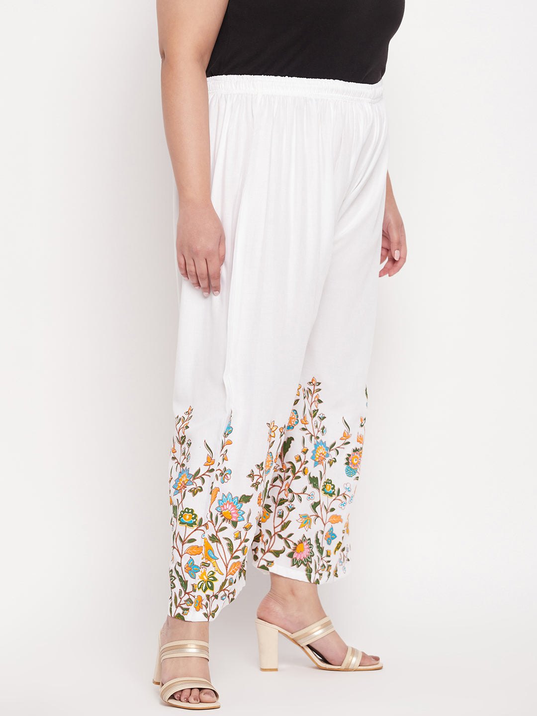 White printed rayon palazzo with floral design and elastic waistband.