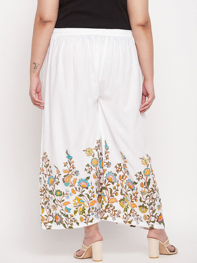 White printed rayon palazzo with floral design and elastic waistband.