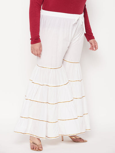 White solid cotton flared gharara with Gotta Patti detailing and elasticated waistband.