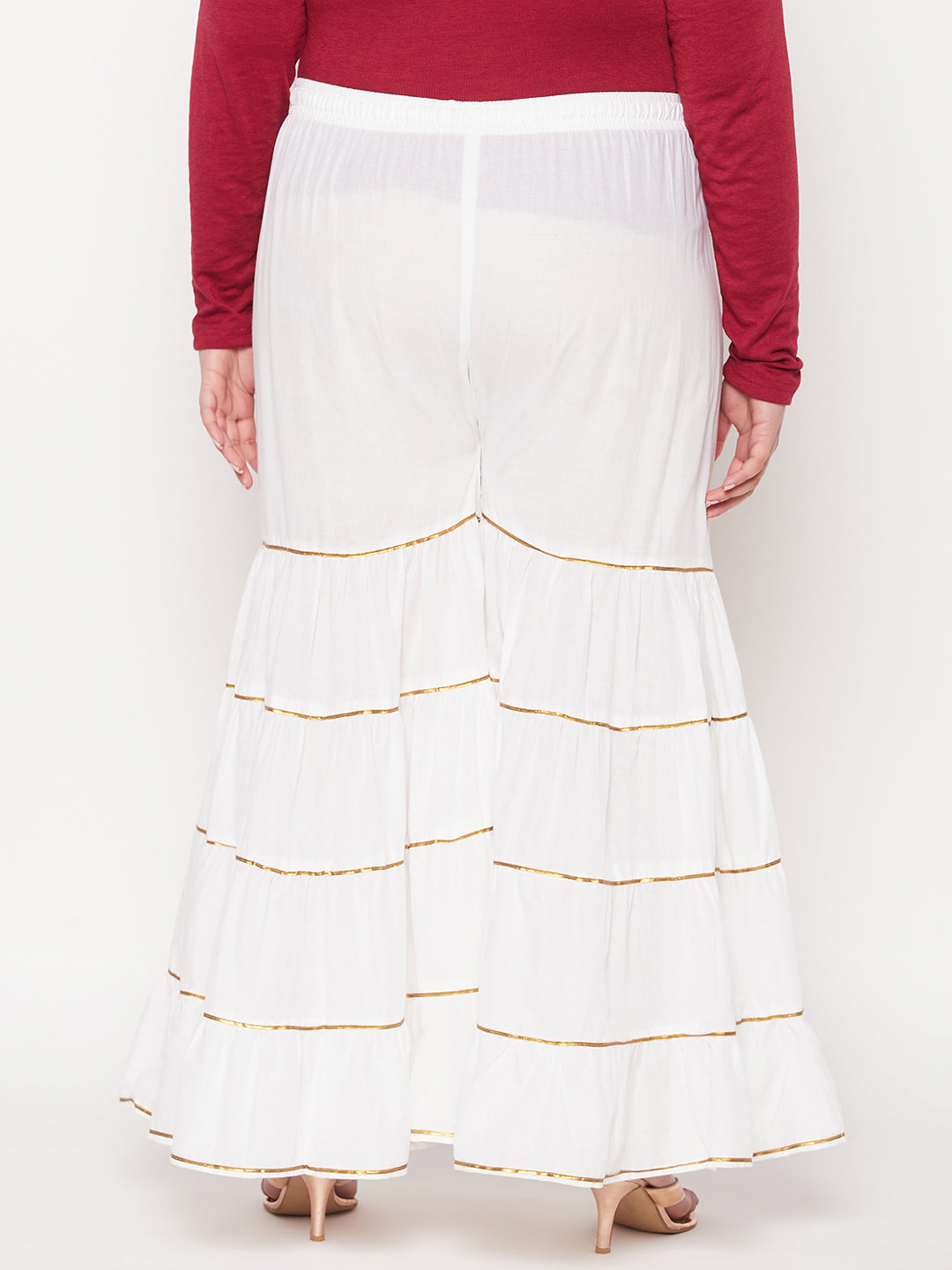 White solid cotton flared gharara with elasticated waistband and Gotta Patti detailing.