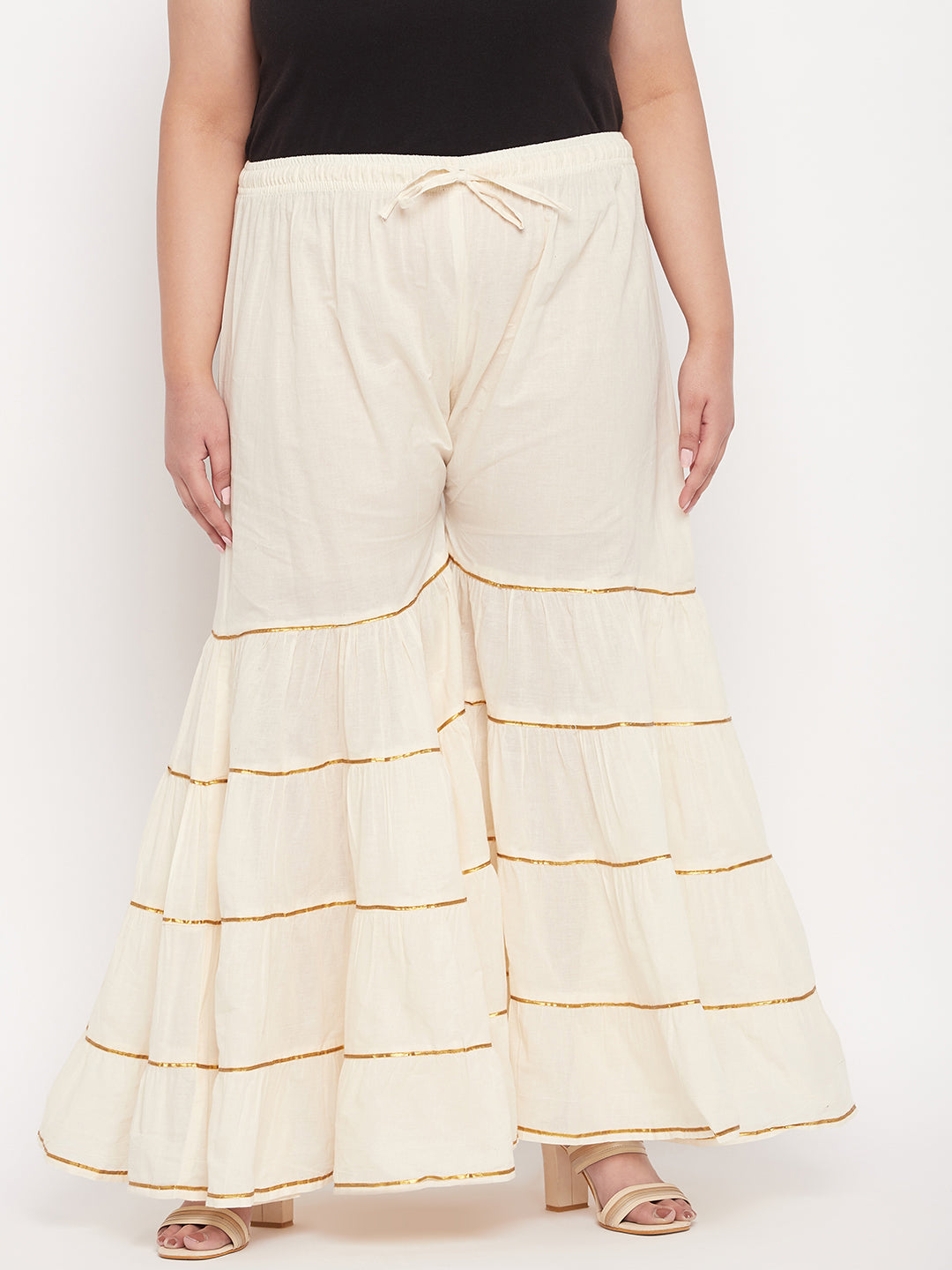 Off-White solid cotton flared Gharara with Gotta Patti detailing and elasticated waistband.