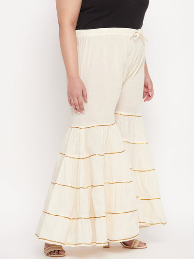 Off-white solid cotton flared gharara with Gotta Patti detailing and elasticated waistband.