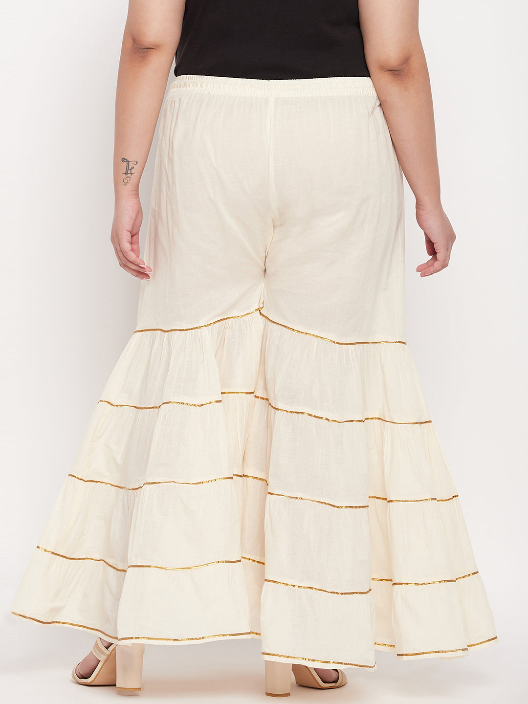 Off-White solid cotton flared gharara with Gotta Patti detailing and elasticated waistband.