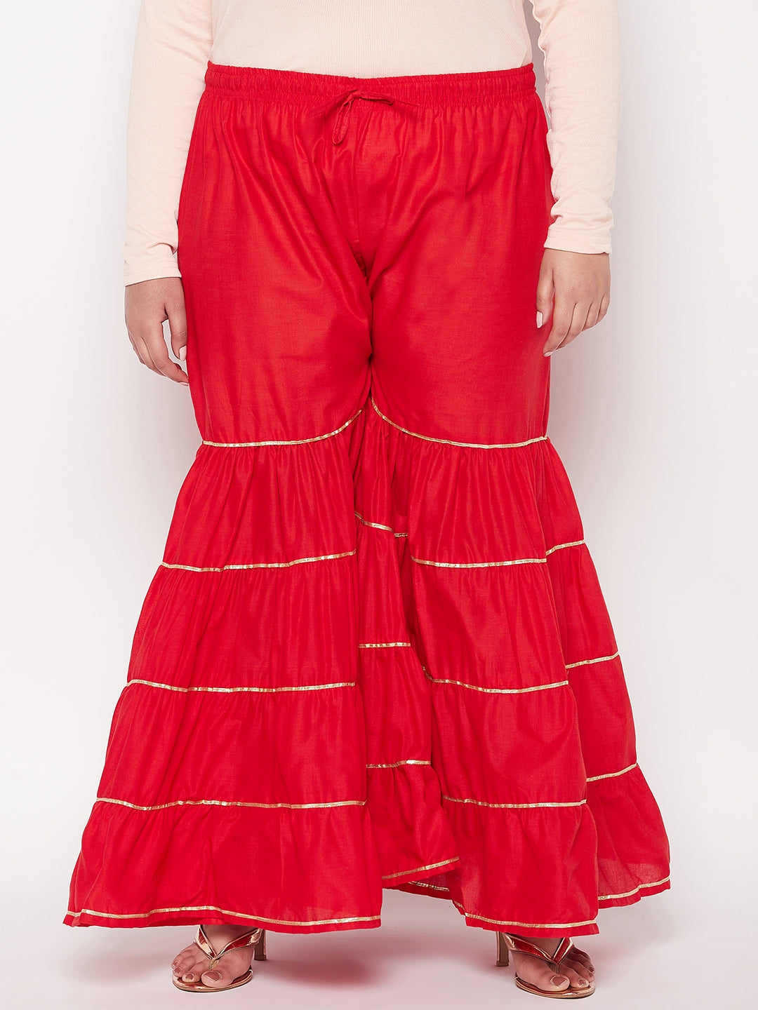 Red solid cotton flared gharara with elasticated waistband and drawstring.