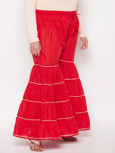 Red solid cotton flared gharara with gota patti design, elasticated waistband, and drawstring.