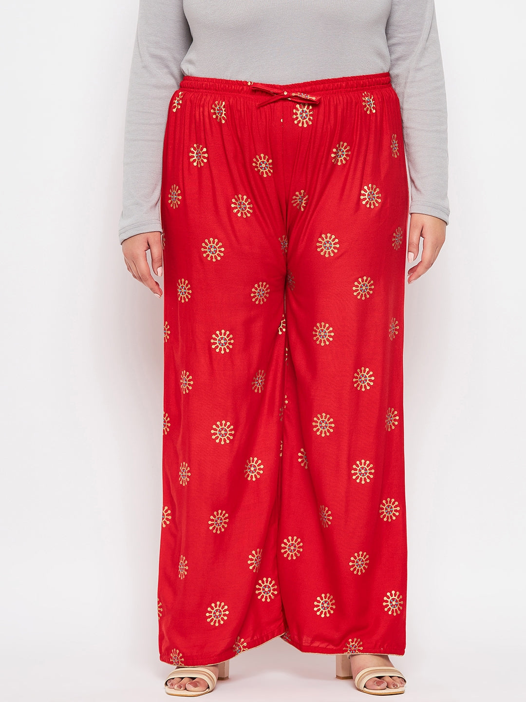 Red printed rayon palazzo with elasticated waistband and drawstring.