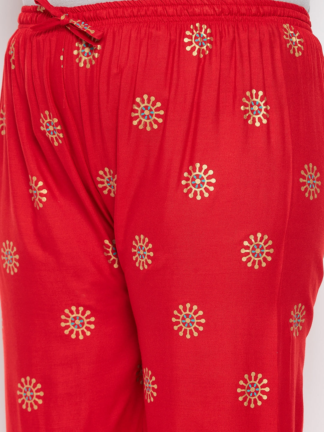 Red printed rayon palazzo with elasticated waistband and drawstring.