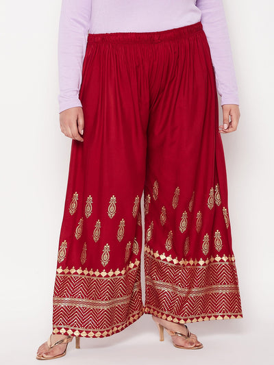 Maroon printed wide leg rayon palazzo with elastic waistband and drawstring.