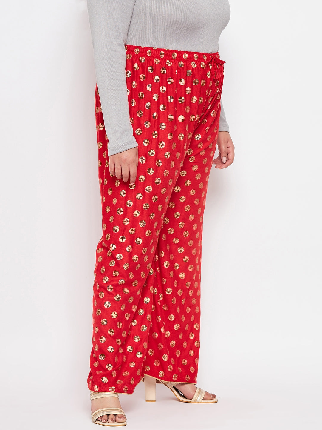 Red polka dot printed palazzo with elasticated waistband and drawstring.