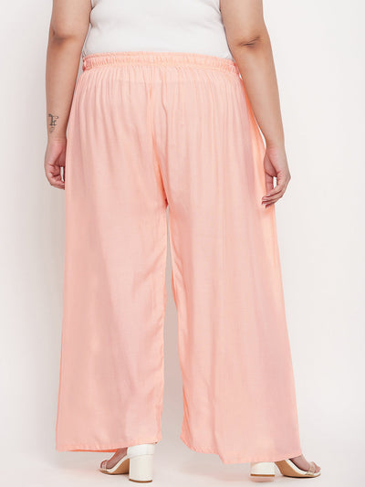 Peach solid rayon palazzo with elasticated waistband and drawstring.