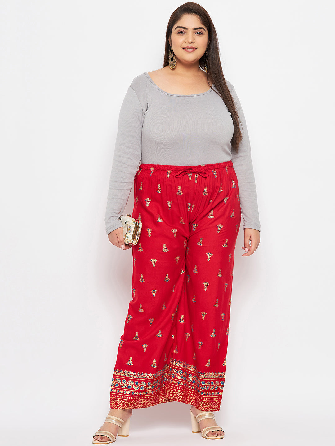 Red printed rayon straight palazzo with elasticated waistband and drawstring.