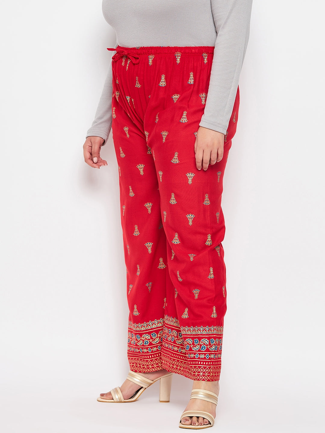 Red printed rayon straight palazzo with elasticated waistband and drawstring.