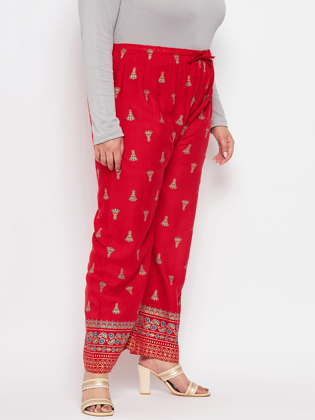 Red printed rayon straight palazzo with elasticated waistband and drawstring.