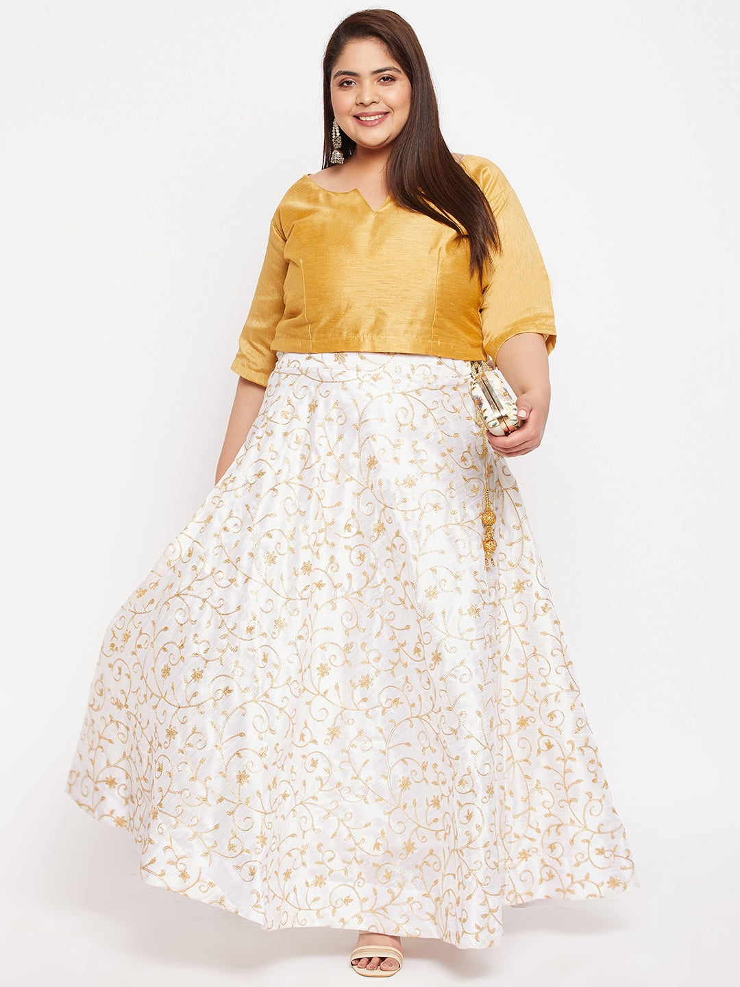 White and gold embroidered flared skirt with elastic waistband and drawstring.