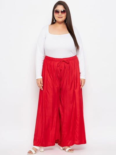 Red solid rayon flared sharara with elasticated waistband and drawstring.