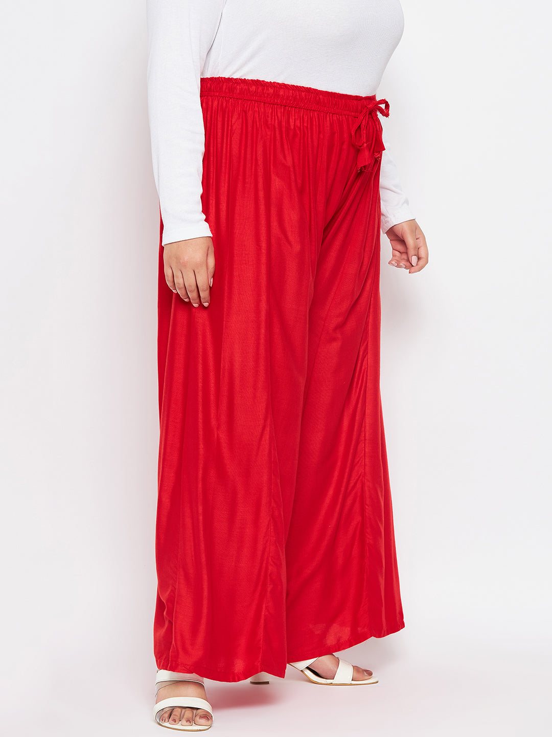 Red solid rayon flared sharara with elastic waistband and drawstring.