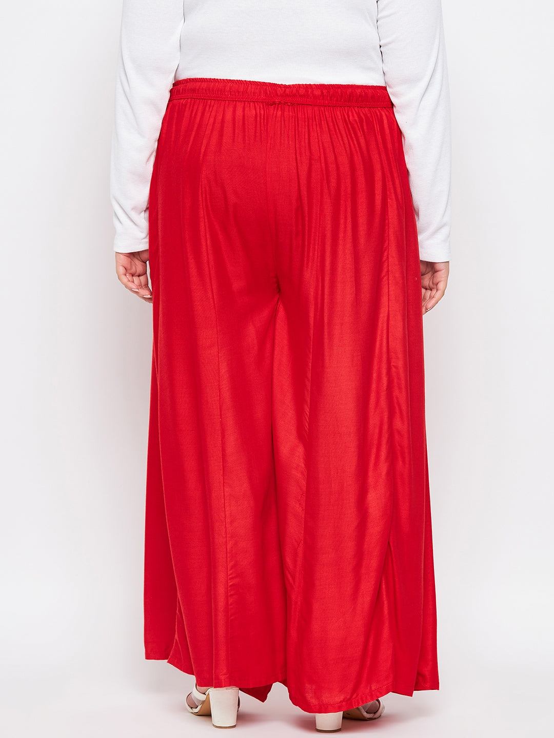 Red solid rayon flared sharara with elasticated waistband and drawstring.