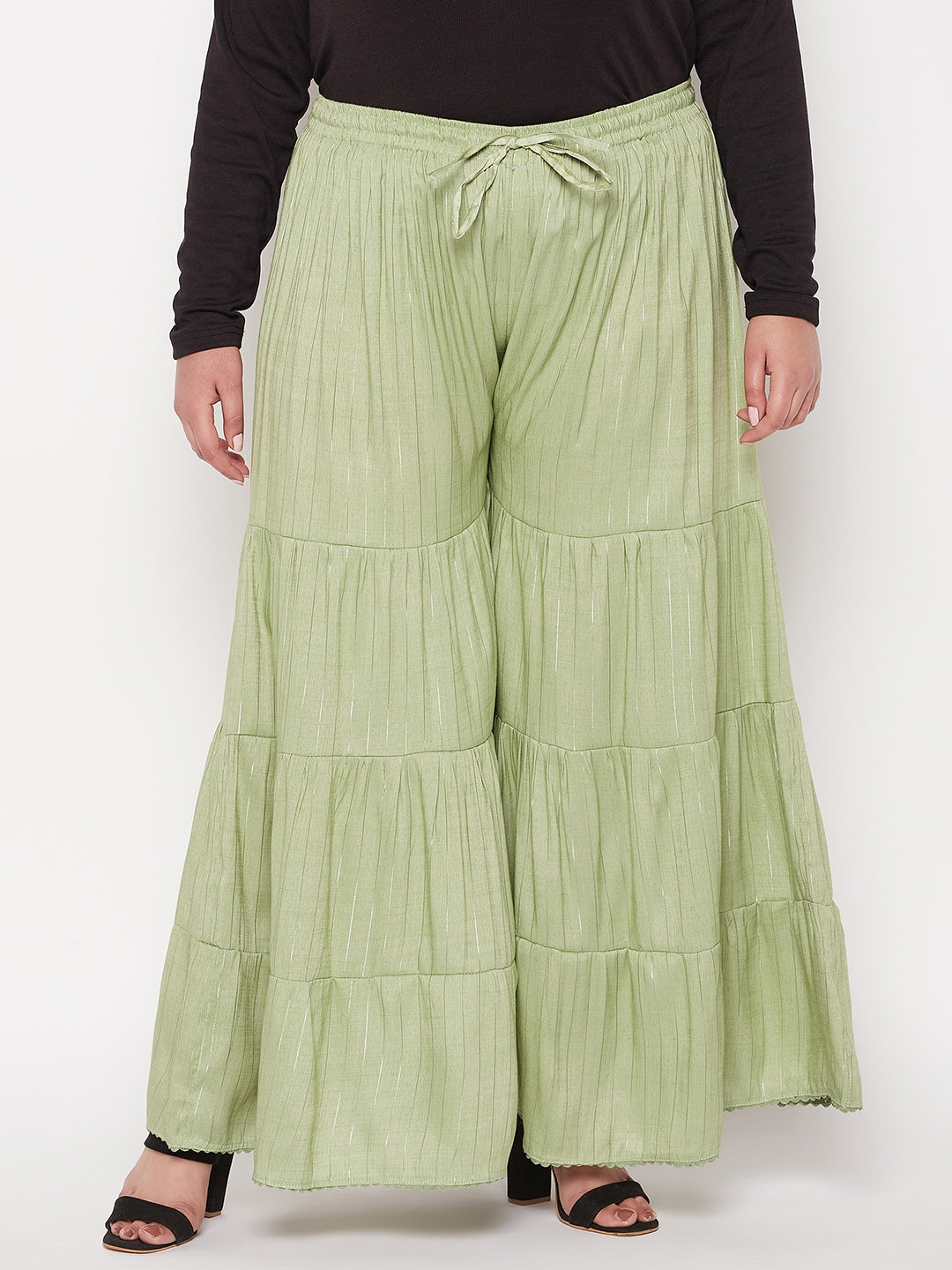 Pista green striped rayon flared gharara with elasticated waistband and drawstring.