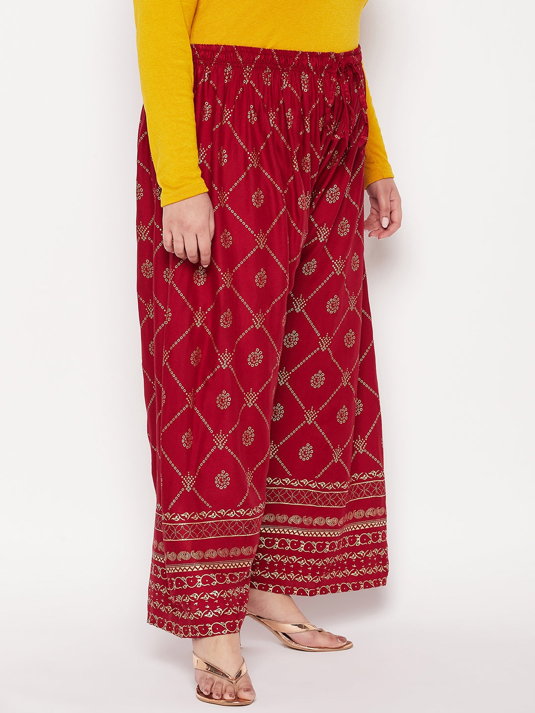 Maroon printed rayon palazzo with elasticated waistband and drawstring.