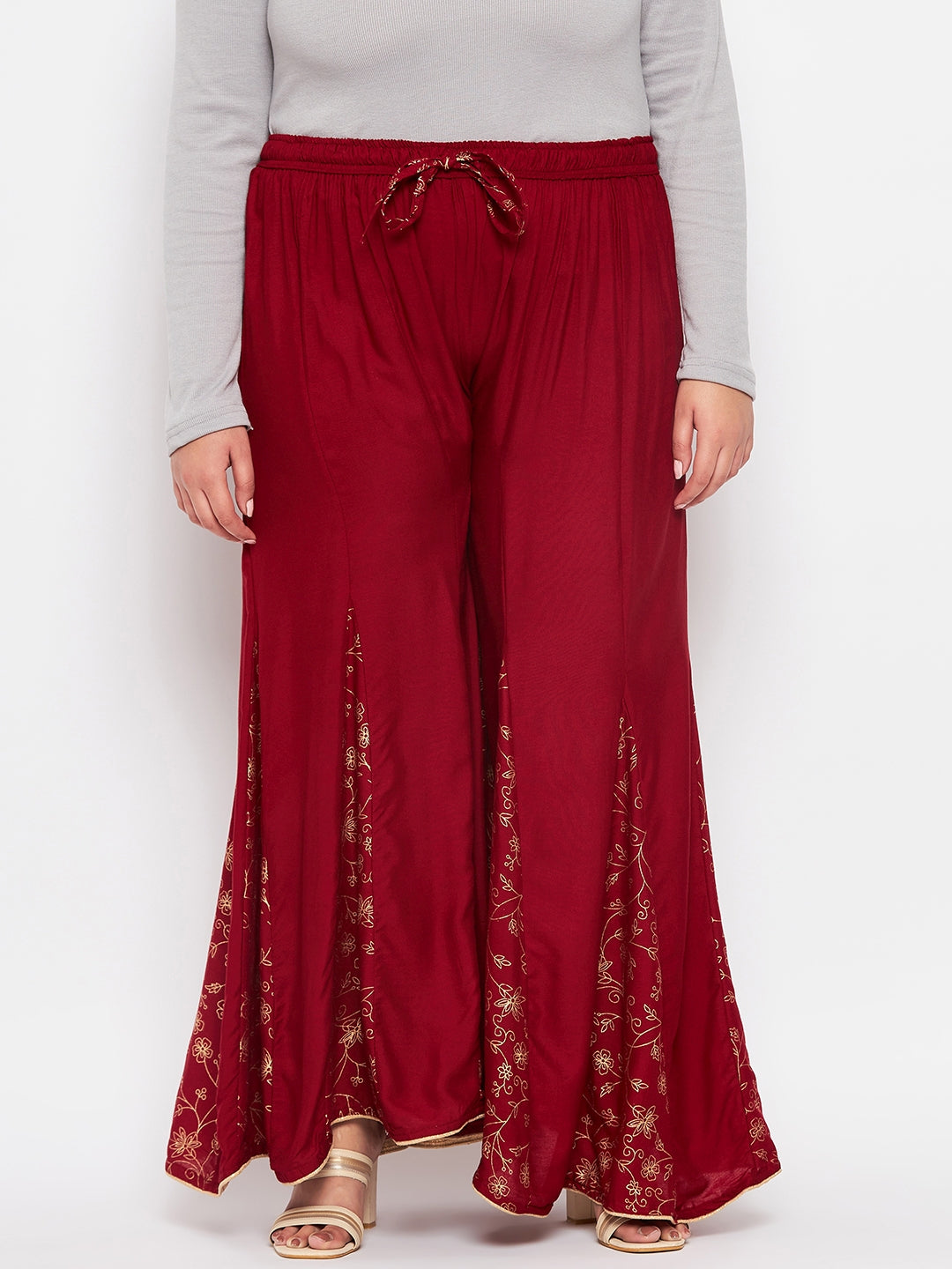 Maroon printed rayon flared sharara with elasticated waistband and drawstring.