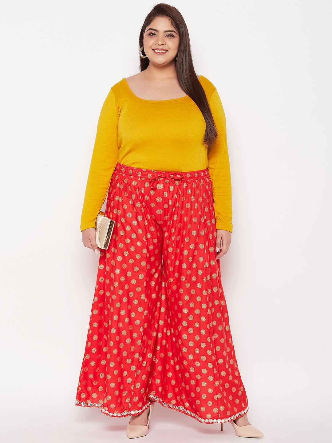 Red polka dot rayon sharara with elasticated waistband and drawstring.