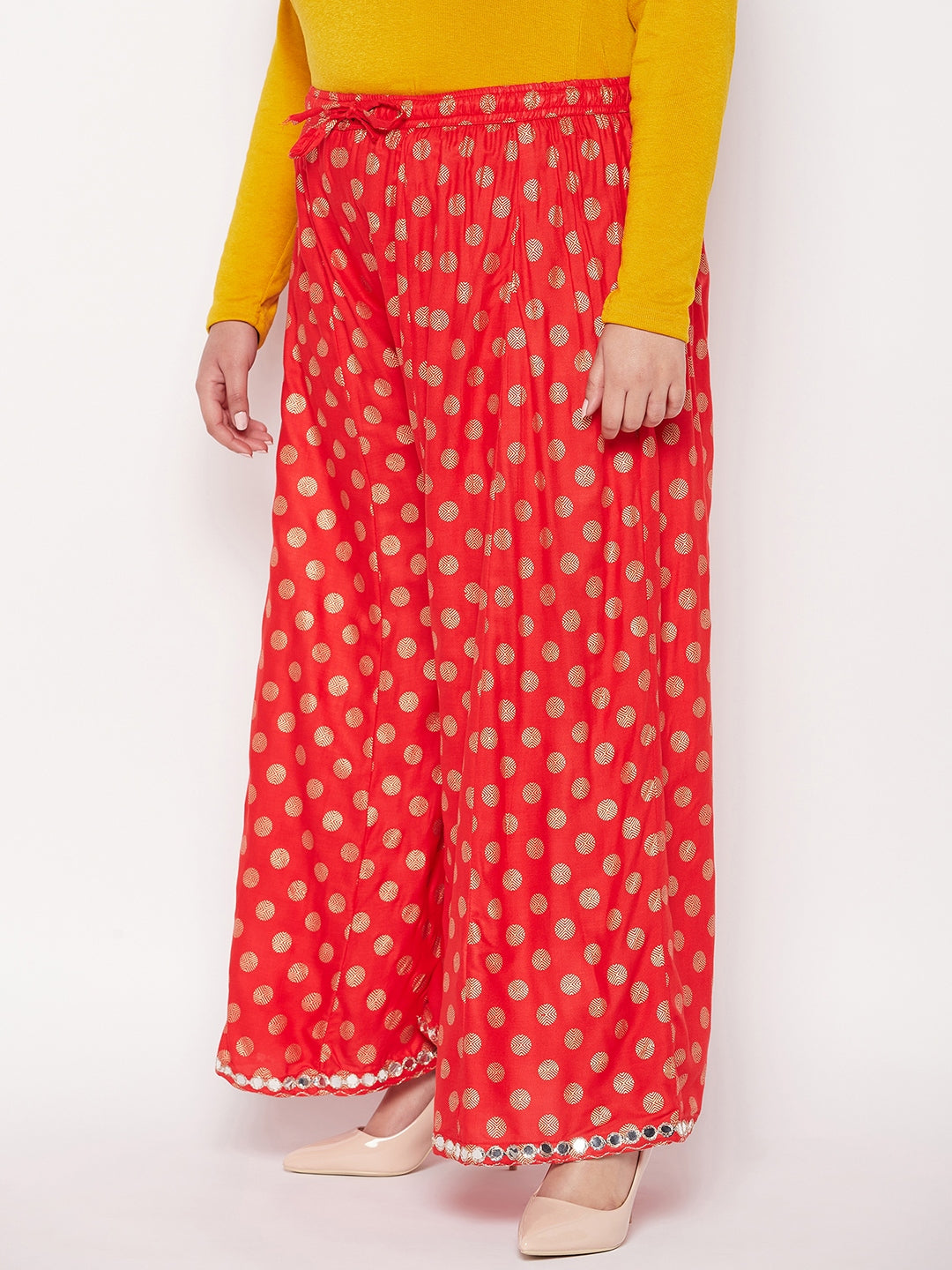 Red polka dot rayon sharara with wide leg design and elasticated waistband.