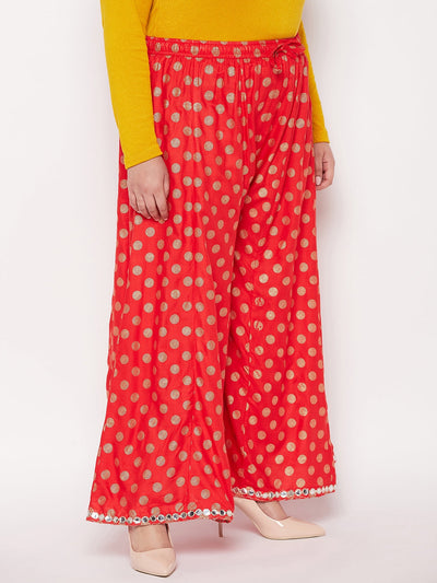 Red polka dot rayon sharara with wide legs and elastic waistband.