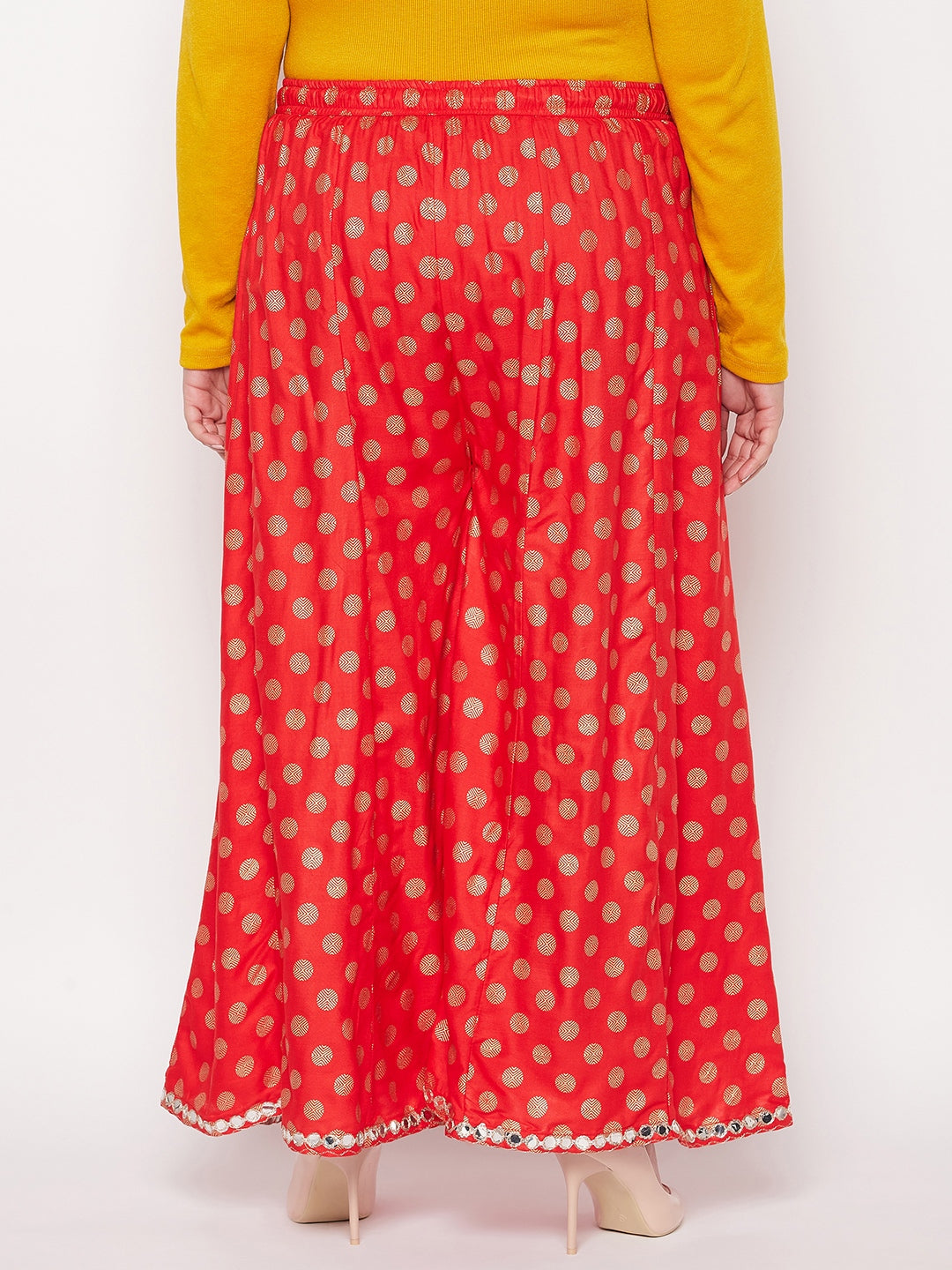 Red polka dot rayon sharara with elasticated waistband and drawstring.