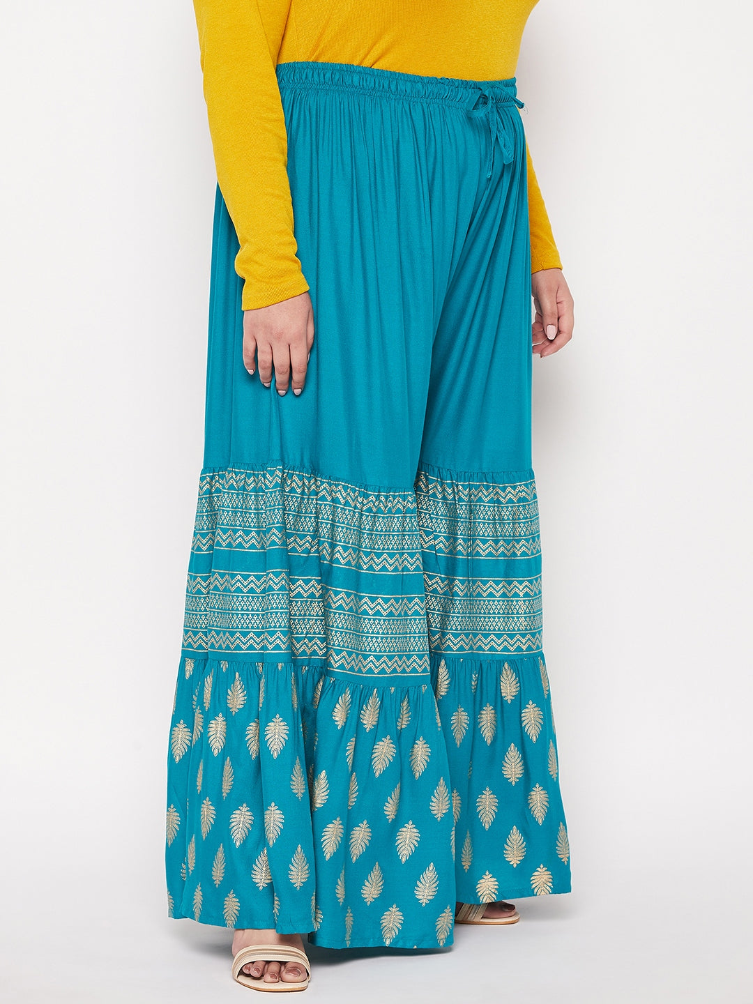 Rama green printed rayon flared gharara with elasticated waistband and drawstring.